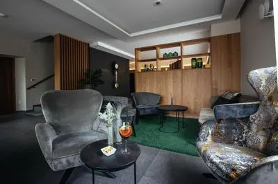 a living room with chairs and a table at Hotel Rablanderhof in Rablà