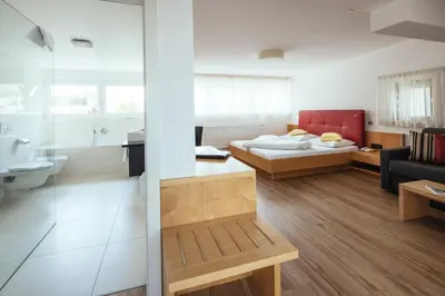 a room with a living room and a bedroom at Hotel Rablanderhof in Rablà