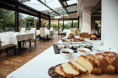 a table with bread and pastries on it at Hotel Rablanderhof in Rablà
