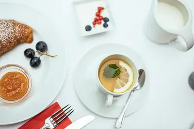 a cup of coffee and a plate of food at Hotel Rablanderhof in Rablà