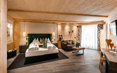 a hot tub in the snow next to a building at Alpine Boutique Villa Gabriela - Adults Only in Castelrotto