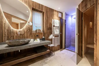 a bedroom with a bed and a desk and a chair at Alpine Boutique Villa Gabriela - Adults Only in Castelrotto