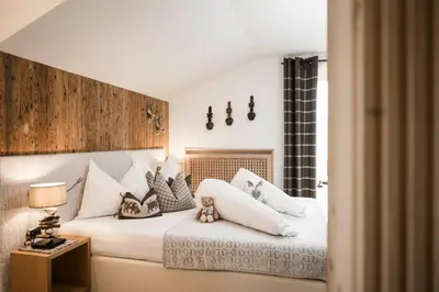 a wooden sauna with a bucket in a room at Alpine Boutique Villa Gabriela - Adults Only in Castelrotto