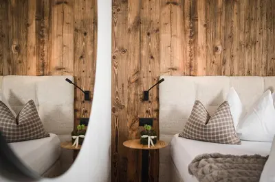 a bedroom with a large bed with white pillows at Alpine Boutique Villa Gabriela - Adults Only in Castelrotto