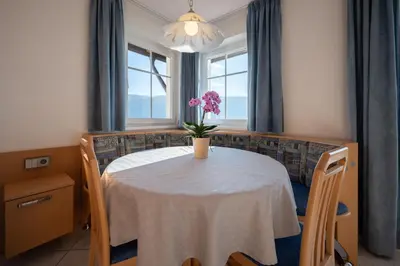 a dining room table with a vase of flowers on it at Residence Treyer in Terento
