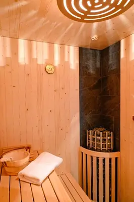 a room with a sauna with a clock on the wall at Residence Treyer in Terento