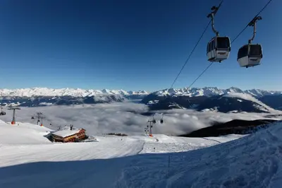 a ski lift on top of a snow covered mountain at Residence Treyer in Terento
