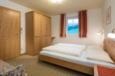 a bedroom with a bed and a window at Residence Treyer in Terento