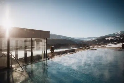 a swimming pool with a fire hydrant in the snow at Hotel Solvie in Falzes