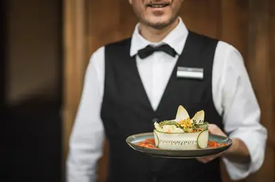 a man holding a plate of food on a plate at Hotel Lanerhof active/spa/balance in San Lorenzo di Sebato