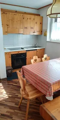 a kitchen with a table with a red and white table cloth at Apartment 18 Federico Bandi Cavalese in Cavalese