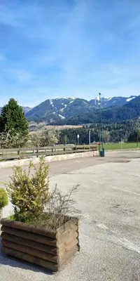a planter in the middle of a road with mountains at Apartment 18 Federico Bandi Cavalese in Cavalese