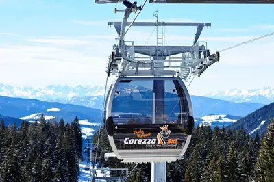 a ski lift with a sign on the side of a mountain at Hotel Castel Latemar in Carezza al Lago