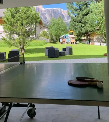 a ping pong table with a tennis ball on it at Garni La Vara in Corvara in Badia