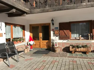 a porch of a house with a santa hat at Garni La Vara in Corvara in Badia
