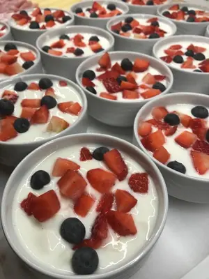 a group of bowls filled with fruit and yogurt at Garni La Vara in Corvara in Badia