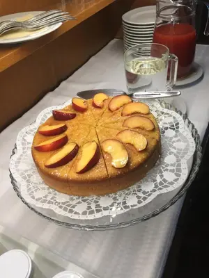 a cake on a glass plate on a table at Garni La Vara in Corvara in Badia