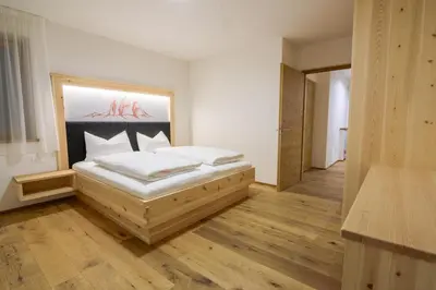 a bedroom with a bed with a painting on the wall at Residence Stefansdorf in Brunico
