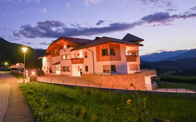 a large house on the side of a road at Residence Stefansdorf in Brunico