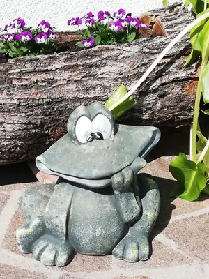 a statue of a frog on a rock at Zimmervermietung Gröberhof in Schenna