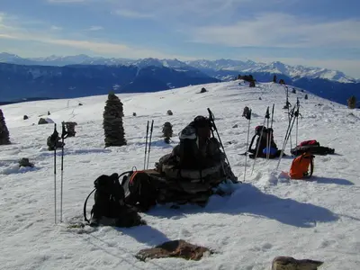 a snow covered slope with skis and backpacks on a mountain at Zimmervermietung Gröberhof in Schenna