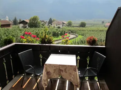 a table and chairs on a balcony with a view at Garni Weghueb in Rablà