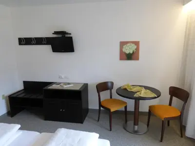 a room with a table and chairs and a desk at Garni Weghueb in Rablà