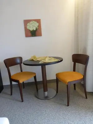 a table with two chairs and a table with chips on it at Garni Weghueb in Rablà