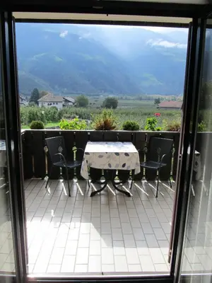 a table and chairs on a balcony with a view at Garni Weghueb in Rablà