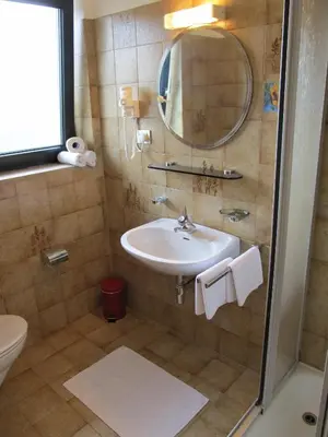 a bathroom with a sink and a mirror at Garni Weghueb in Rablà