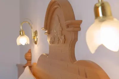 a wooden model of a building next to a lamp at Residence Barbara in Colfosco