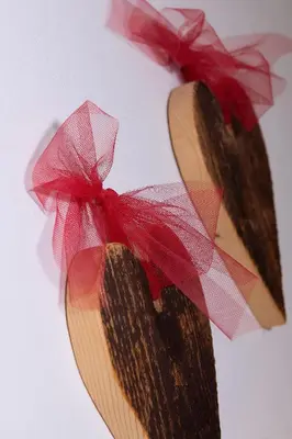 a wooden heart with a red bow on it at Residence Barbara in Colfosco