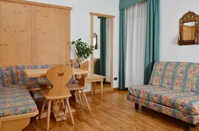a living room with a couch and a table at Residence Taufer in San Martino di Castrozza