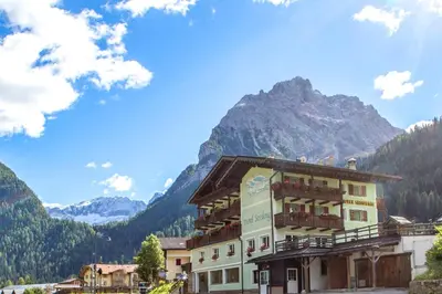 a hotel with a mountain in the background at Hotel Sassleng in Canazei