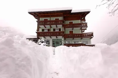 a building on top of a pile of snow at Hotel Sassleng in Canazei