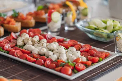 a tray of tomatoes and other vegetables on a table at Hotel Sigmundskron in Appiano sulla Strada del Vino