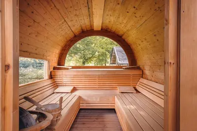 a sauna with a window in a wooden cabin at Hotel Sigmundskron in Appiano sulla Strada del Vino