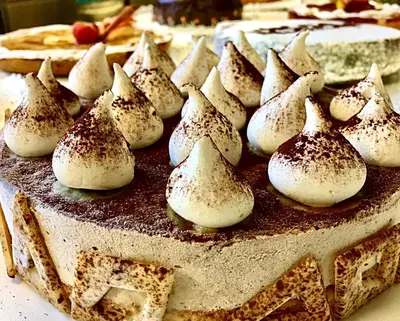 a chocolate cake with marshmallows on top of it at Hotel Mirabello - Slow Hotel Benessere in Fiera di Primiero