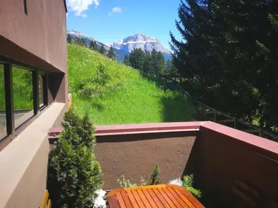 a view of a mountain from the balcony of a house at Luce Delle Dolomiti con navetta e sala giochi in Mazzin