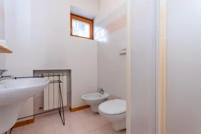 a bathroom with a toilet and a sink at Casa Stella in Falcade