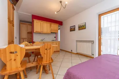 a kitchen with a table and chairs in a room at Casa Stella in Falcade