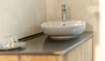 a white sink on a counter in a bathroom at Garni Hotel Melissa in Castelrotto