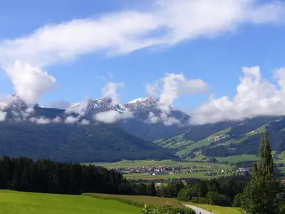 a mountain in the distance with a green field at Appartements Wiesenheim in Rasun di Sopra