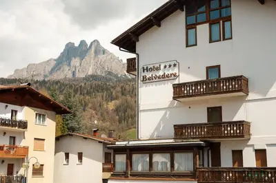 a hotel building with a mountain in the background at Albergo Belvedere in Fiera di Primiero