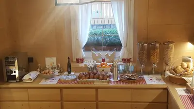a table with a bunch of food on it at Hotel Villa Gaia in Cortina dʼAmpezzo