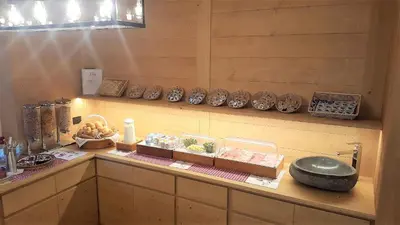 a counter with bowls and other items on it at Hotel Villa Gaia in Cortina dʼAmpezzo