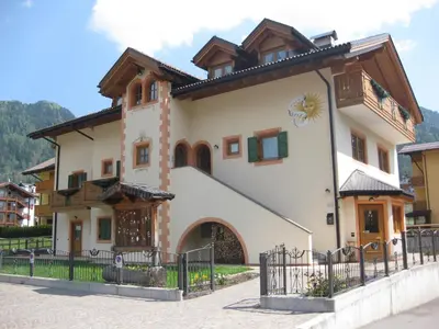 a large house with a fence in front of it at Affittacamere Villa Sole in Fiera di Primiero
