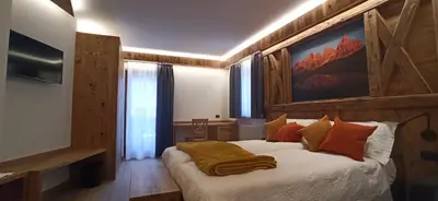 a bedroom with a bed with a blanket on it at Affittacamere Villa Sole in Fiera di Primiero