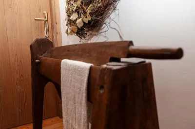a wooden towel rack next to a door at Albergo Lozen in Canale San Bovo