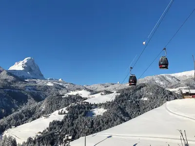 a ski lift with a snow covered mountain at Fless in San Martino in Badia